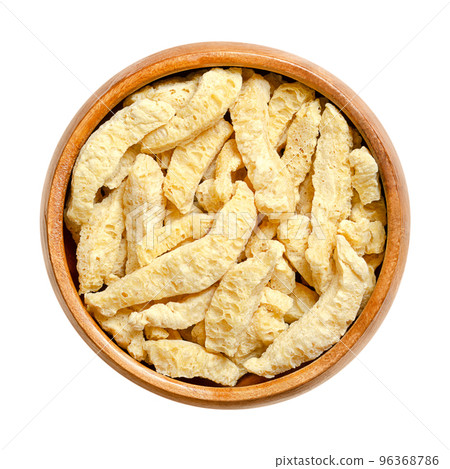 Soy curls, a soy based meat alternative, in a wooden bowl. Big soya chunks, made from boiling and dehydrating soybeans, with a texture similar to chicken. Vegan and plant-based meat substitute. Photo. Soy curls, a soy based meat alternative, in a wooden bowl. Big soya chunks, made from boiling and dehydrating soybeans, with a texture similar to chicken. Vegan and plant-based meat substitute. Photo. 96368786