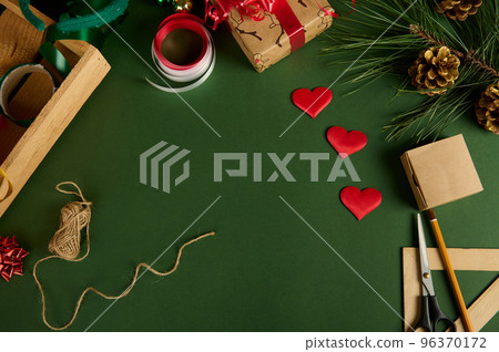 Beautiful Christmas background with wrapping materials and heart shaped decor for packing presents. Copy space. Mockup 96370172