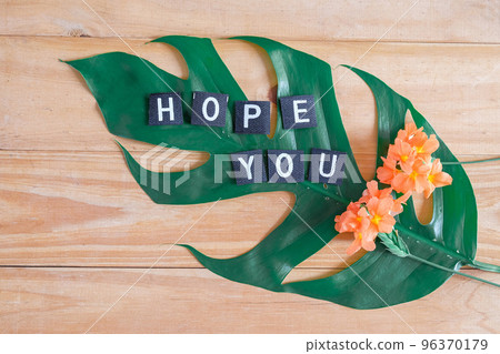Hope you tag with flower on wood table. 96370179