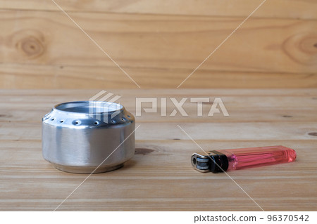 Alcohol stove home made for camping on table. 96370542