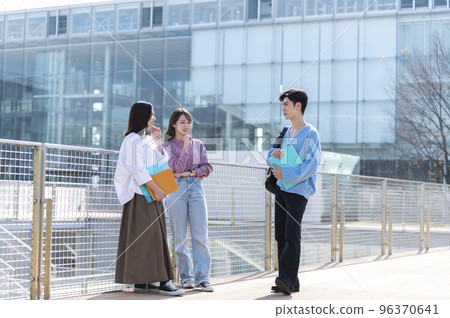 Three male and female college students chatting Three male and female college students chatting 96370641