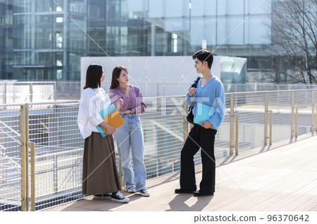 Three male and female college students chatting 96370642