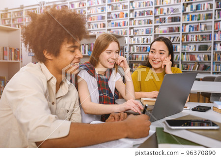 University students are studying in a library together as teamwork for preparation 96370890