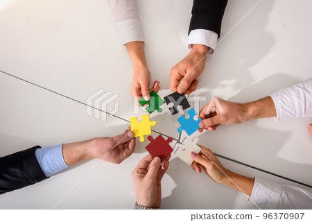 Teamwork of partners connect puzzle pieces as integration and startup 96370907