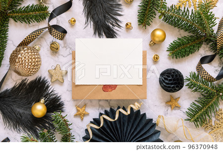 Blank card between black and golden Christmas decorations and fir tree branches top view 96370948