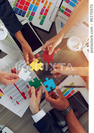 Teamwork of partners connect puzzle pieces as integration and startup 96370970
