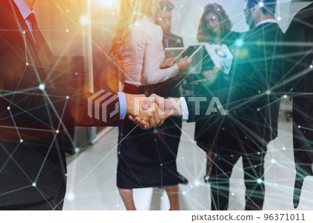 Handshaking of business person in office as teamwork and partnership 96371011