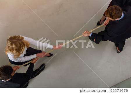 Group of business competitors pull a rope as a challenge Group of business competitors pull a rope as a challenge 96371676