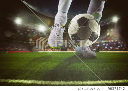 Close up of a soccer scene with player kicking the ball at the stadium Close up of a soccer scene with player kicking the ball at the stadium 96371742