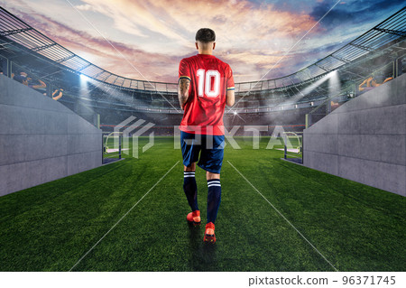 Skilled football player with the number ten makes his entrance to the playing field at the stadium 96371745