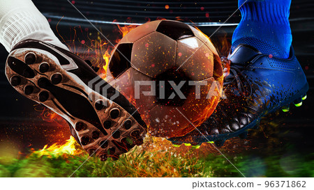 Soccer players with fiery soccerball during the match 96371862
