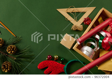 Christmas background with wrapping materials - decorative paper and ribbons for packaging presents. Boxing Day. Diy gift Christmas background with wrapping materials - decorative paper and ribbons for packaging presents. Boxing Day. Diy gift 96372004