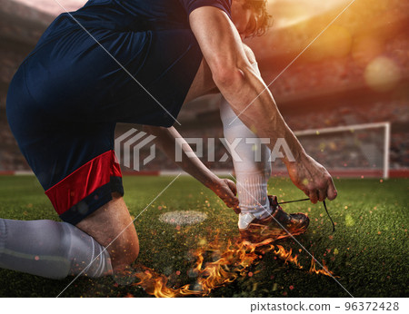 Soccer player with fiery shoe ready to play 96372428