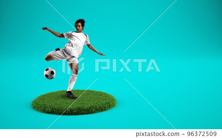 Soccer players kicking the ball on a grassy plate with cyan background Soccer players kicking the ball on a grassy plate with cyan background 96372509