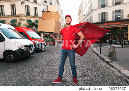 Superhero man with red uniform in front of the shops for delivery and pickup of the goods 96372667