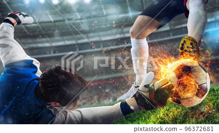Goalkeeper tries to catch a fiery soccer ball Goalkeeper tries to catch a fiery soccer ball 96372681