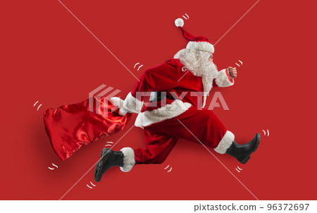 Santa claus runs fast to deliver all gifts Santa claus runs fast to deliver all gifts 96372697