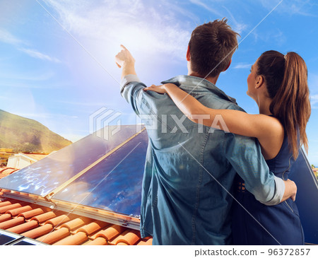 Family uses renewable energy system with solar panel Family uses renewable energy system with solar panel 96372857