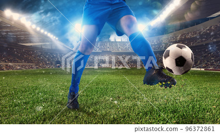 Soccer player ready to kicks the ball at the stadium 96372861