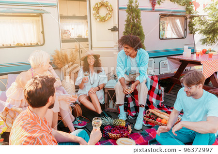 Friends have a picnic with a camper in a sunny day 96372997