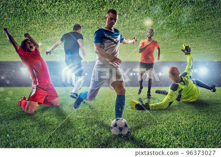 Football scene with competing football players at the stadium 96373027