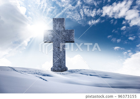 Large Stone Christian Cross in a Mountain Landscape with Snow 96373155