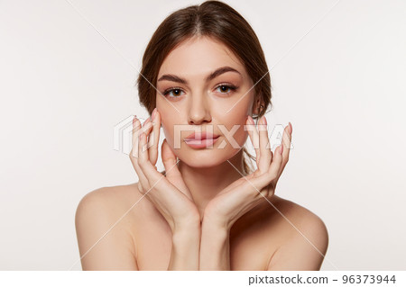 Portrait of young beautiful woman with perfect smooth skin isolated over white background. Perfect face, taking care after skin condition 96373944