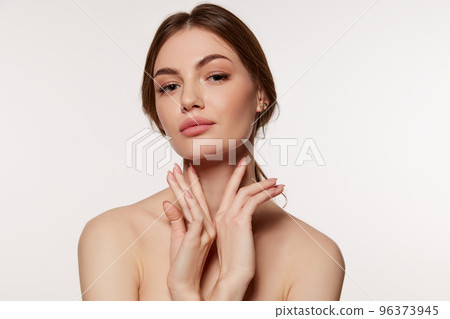 Portrait of young beautiful woman with perfect smooth skin isolated over white background. Facebuilding. 96373945