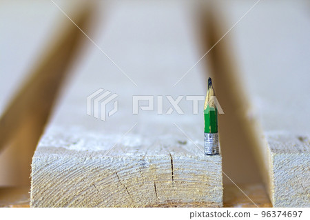 Wooden boards table top with one small pencil 96374697