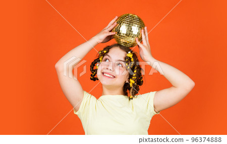 Retro party. Child hold golden disco ball. Cheerful girl with disco ball. Fashion kid posing with curlers in hair. Night club. Hairdresser salon. Fancy teen. Hairstyle for disco party. Have fun Retro party. Child hold golden disco ball. Cheerful girl with disco ball. Fashion kid posing with curlers in hair. Night club. Hairdresser salon. Fancy teen. Hairstyle for disco party. Have fun 96374888
