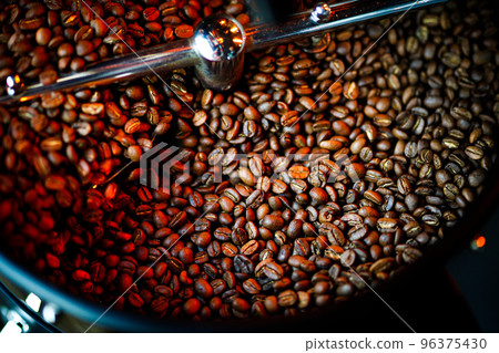 Coffee beans in a coffee machine, in dark colors. 96375430