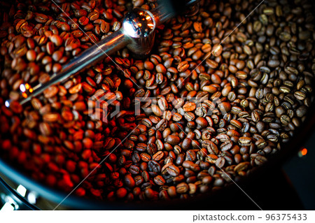 Coffee beans in a coffee machine, in dark colors. Coffee beans in a coffee machine, in dark colors. 96375433