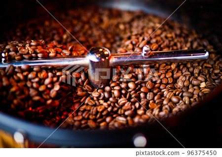 Coffee beans in a coffee machine, in dark colors. 96375450
