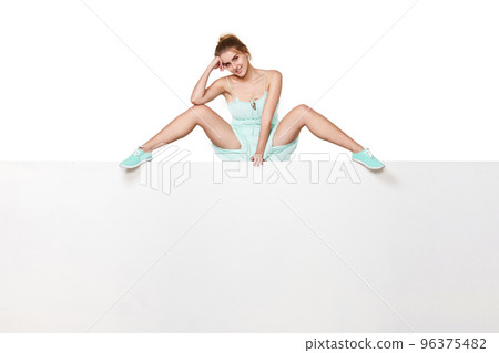 Beautiful woman in dress sitting on white banner. Beautiful woman in dress sitting on white banner. 96375482