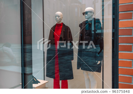 Female mannequins wear luxury style winter clothes. Female mannequins in shop window. Display of a clothing store Female mannequins wear luxury style winter clothes. Female mannequins in shop window. Display of a clothing store 96375848