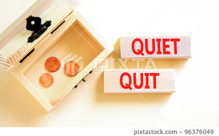 Quiet quit symbol. Concept words Quiet quit on wooden blocks. Beautiful white table white background. Wooden chest with coins. Business and quiet quit concept. Copy space. 96376049