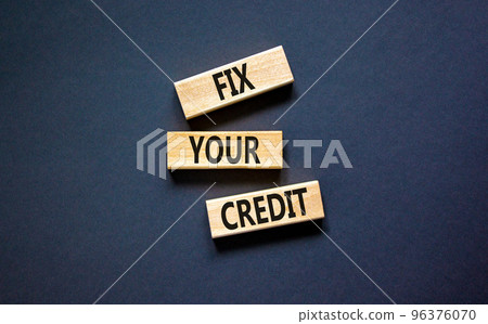 Fix your credit symbol. Concept words Fix your credit on wooden blocks on a beautiful black table black background. Business, finacial and fix your credit concept. Copy space. 96376070