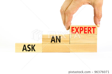 Ask an expert symbol. Concept words Ask an expert on wooden blocks on a beautiful white table white background. Businessman hand. Business and ask an expert concept. Copy space. 96376071