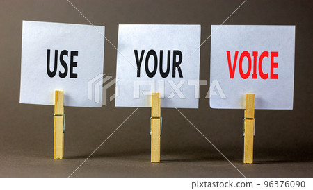 Use your voice symbol. Concept words Use your voice on white paper on a beautiful grey table grey background. Business and use your voice concept. Copy space. 96376090