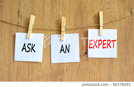 Ask an expert symbol. Concept words Ask an expert on white paper on a beautiful wooden table wooden background. Business and ask an expert concept. Copy space. Ask an expert symbol. Concept words Ask an expert on white paper on a beautiful wooden table wooden background. Business and ask an expert concept. Copy space. 96376091