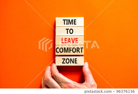 Leave comfort zone symbol. Concept words Time to leave comfort zone on wooden blocks. Businessman hand. Beautiful orange background. Business time to leave comfort zone concept. Copy space. Leave comfort zone symbol. Concept words Time to leave comfort zone on wooden blocks. Businessman hand. Beautiful orange background. Business time to leave comfort zone concept. Copy space. 96376136