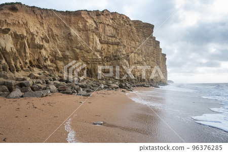 Rock formations, sandstone cliffs in West Bay beach, located near Bridport in Dorset, United Kingdom. Part of famous Jurassic coast, World Heritage Site, selective focus Rock formations, sandstone cliffs in West Bay beach, located near Bridport in Dorset, United Kingdom. Part of famous Jurassic coast, World Heritage Site, selective focus 96376285