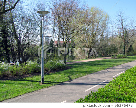Park in Strasbourg near the river Ile. April 2009. Leaves on the trees bloom. France, beautiful spring landscape 96376472