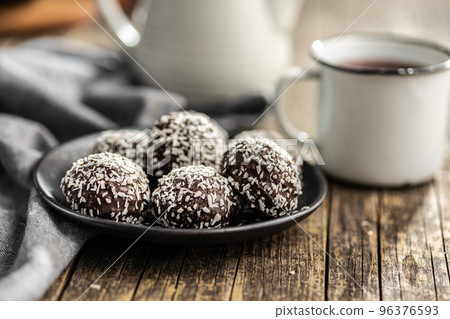 Coconut chocolate balls on plate. Coconut chocolate balls on plate. 96376593