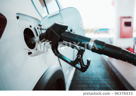 Fuel pump fill a tank of a car in a station Fuel pump fill a tank of a car in a station 96376833