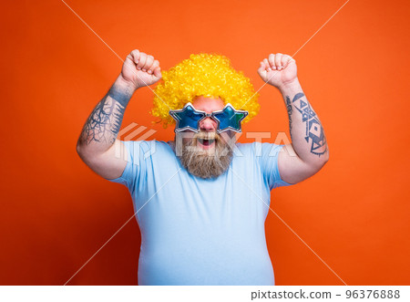 Funny man with wig and sunglasses is happy and exults for something Funny man with wig and sunglasses is happy and exults for something 96376888