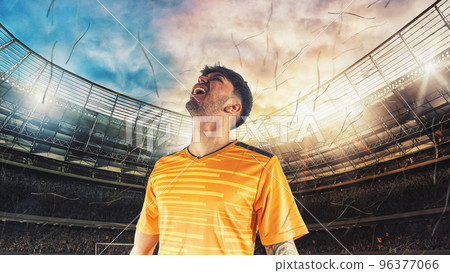Soccer player in yellow uniform rejoices for the victory at the stadium 96377066