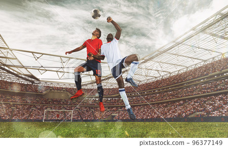 Football action with competing soccer players jumping to hit the ball with head 96377149
