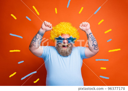Funny man with wig and sunglasses is happy and exults for something 96377178