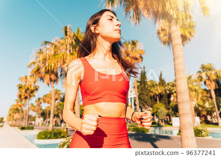 Woman does gym stretching exercises outdoor in a sunny day 96377241